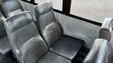 Interior seating of a 2014 Freightliner Thomas bus with black vinyl seats arranged in rows