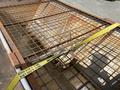 A 2010 Ford F-550 with a rusted metal grid covering its truck bed
