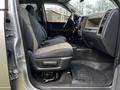 Interior view of a 2012 RAM 3500 showing the driver's seat and console with fabric upholstery and rubber floor mat