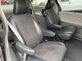 Two front seats of a 2013 Toyota Sienna with fabric upholstery and adjustable headrests