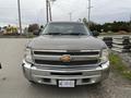 A 2013 Chevrolet Silverado Hybrid with a chrome grille and a prominent Chevrolet logo on the front