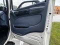 The image shows the interior door panel of a 2006 Hino 268 featuring a blue handle and a smooth design with a small storage area built into the panel