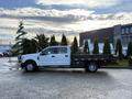 A 2017 Ford F-350 Super Duty flatbed truck parked with a flatbed and dual rear wheels