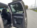 A 2013 Chevrolet Silverado Hybrid with an open driver's side door showcasing its interior seats and controls