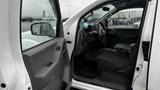 Interior view of a 2016 Nissan Frontier showing the driver's seat steering wheel and dashboard with a partially open door