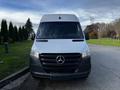 A 2022 Mercedes-Benz Sprinter van facing forward with a prominent grille featuring the Mercedes-Benz logo and sleek headlights