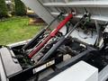 2007 Tennant Sentinel with visible hydraulic lift system featuring red and black hydraulic cylinders and green connectors