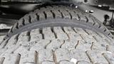 Close-up of a tire tread from a 2006 Ford Econoline showing deep grooves and textured rubber surface