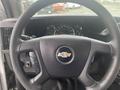 Steering wheel of a 2017 Chevrolet Express with a Chevrolet logo in the center and dashboard gauges visible in the background