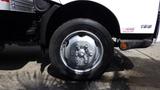 A close-up view of the wheel of a 2016 Hino 195 truck featuring a shiny silver rim and black tire