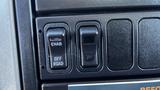 Close-up of control switches in a 2019 International 4300 featuring an emergency brake switch labeled ENAB and an off-road switch labeled OFF ROAD