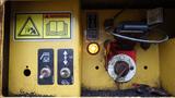 Control panel of a 2019 Caterpillar 972M XE featuring buttons for operation a warning light and warning symbols