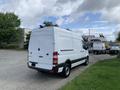 A white 2017 Mercedes-Benz Sprinter van is parked with its rear view shown highlighting its cargo space and distinctive taillights