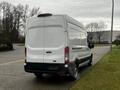 A white 2021 Ford Transit van viewed from the rear with a high roof and a sliding door