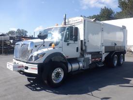 A white 2008 International 7400 truck with a large enclosed cargo area and dual rear wheels