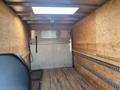 A 2017 Mercedes-Benz Sprinter with a spacious empty cargo area featuring wooden paneling and a loading ramp