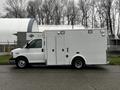 A 2016 Chevrolet Express van with a white exterior and side access door displaying service vehicle features