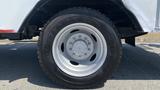 A close-up of a gray wheel and tire from a 2011 Ford F-450 SD showcasing the rim design and tread pattern