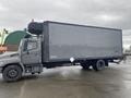 A 2018 Hino 308 truck with a large gray box cargo area and a small lift gate at the rear