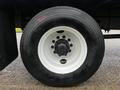 A close-up of a Goodyear tire on a 2020 Hino 338 truck showing black rubber and a white wheel rim with multiple bolts