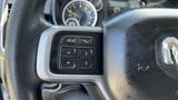 Close-up of the steering wheel controls of a 2019 RAM 3500 featuring buttons for voice recognition and navigation functions