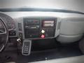 Interior dashboard of a 2006 International 4300 featuring gauges a radio control panel and various buttons and knobs