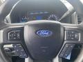 Steering wheel of a 2017 Ford F-550 with control buttons including volume and menu options