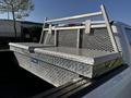 A 2017 Ford F-150 truck with a silver diamond plate tool box mounted in the truck bed