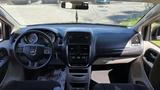 Interior view of a 2016 Dodge Grand Caravan showcasing the dashboard steering wheel and center console