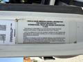 A label attached to a truck door providing vehicle noise emission control information for a 2009 International 7500