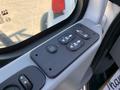 A close-up view of the control panel in a 2007 International 7300 featuring buttons for window controls door locks and automatic functions