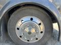 Close-up of a wheel from a 2008 Newmar Canyon Star 36 Foot Class A Motorhome showing a shiny metal rim and tire with outer tread detailing