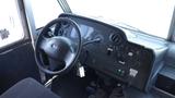 Interior dashboard of a 2011 Ford Econoline featuring the steering wheel gauges and control panels