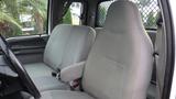 Interior view of a 2008 Ford F-650 showing two gray front seats with fabric upholstery and seat belts