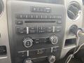 Dashboard of a 2009 Ford F-150 showing the audio and climate control systems with various buttons and knobs