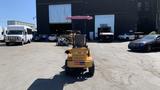 A 2024 Traner TR45 vehicle with a yellow body and a pink canopy parked in a lot.