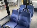 Interior view of a 2018 Chevrolet Express showing two blue upholstered seats with headrests and sturdy armrests