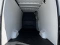 Interior of a 2022 Mercedes-Benz Sprinter van featuring a spacious cargo area with white walls and a black floor