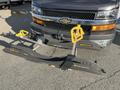 A 2018 Chevrolet Express with a ski and snowboard rack attached to the front featuring yellow and black supports and the text sportworks