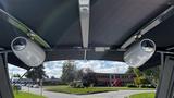 View of the interior of a 2023 Mercury Monterey featuring two white speakers mounted on the ceiling