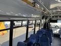 Interior of a 2017 Chevrolet Express showing seats and windows with a visible pole overhead