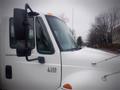 White 2006 International 4300 truck cab featuring large side mirrors with visible model number 4300 on the door