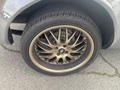 Close-up of a 1966 Ford Mustang wheel featuring gold alloy rims and a black tire with visible tread patterns