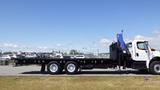 2017 Freightliner M2 106 flatbed truck with a blue hydraulic lift on the side and a black cargo bed