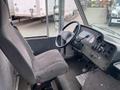 Interior view of a 2011 Ford Utilimaster food truck focusing on the driver's seat and dashboard with various controls and a steering wheel