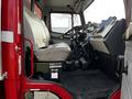 Interior view of a 1994 Freightliner FL80 truck showing the driver's seat and dashboard with controls and instrumentation