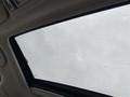 A 2019 Subaru Outback sunroof with rain droplets on the glass showing a cloudy sky above