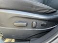 The image shows the seat adjustment controls of a 2012 Kia Sportage featuring two buttons for adjusting the seat position and one button for controlling the seat tilt