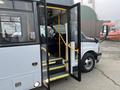 A 2017 Chevrolet Express bus with an open door showing steps and the driver’s seat inside