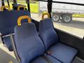 The interior of a 2015 Chevrolet Express with two blue fabric seats featuring yellow headrests and seatbelts